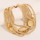 Gold bead and hammer plate necklace