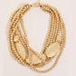 Gold bead and hammer plate necklace